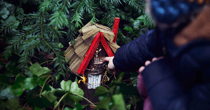 small child pointing at a fairy house on the bowes museum woodland fairy trail